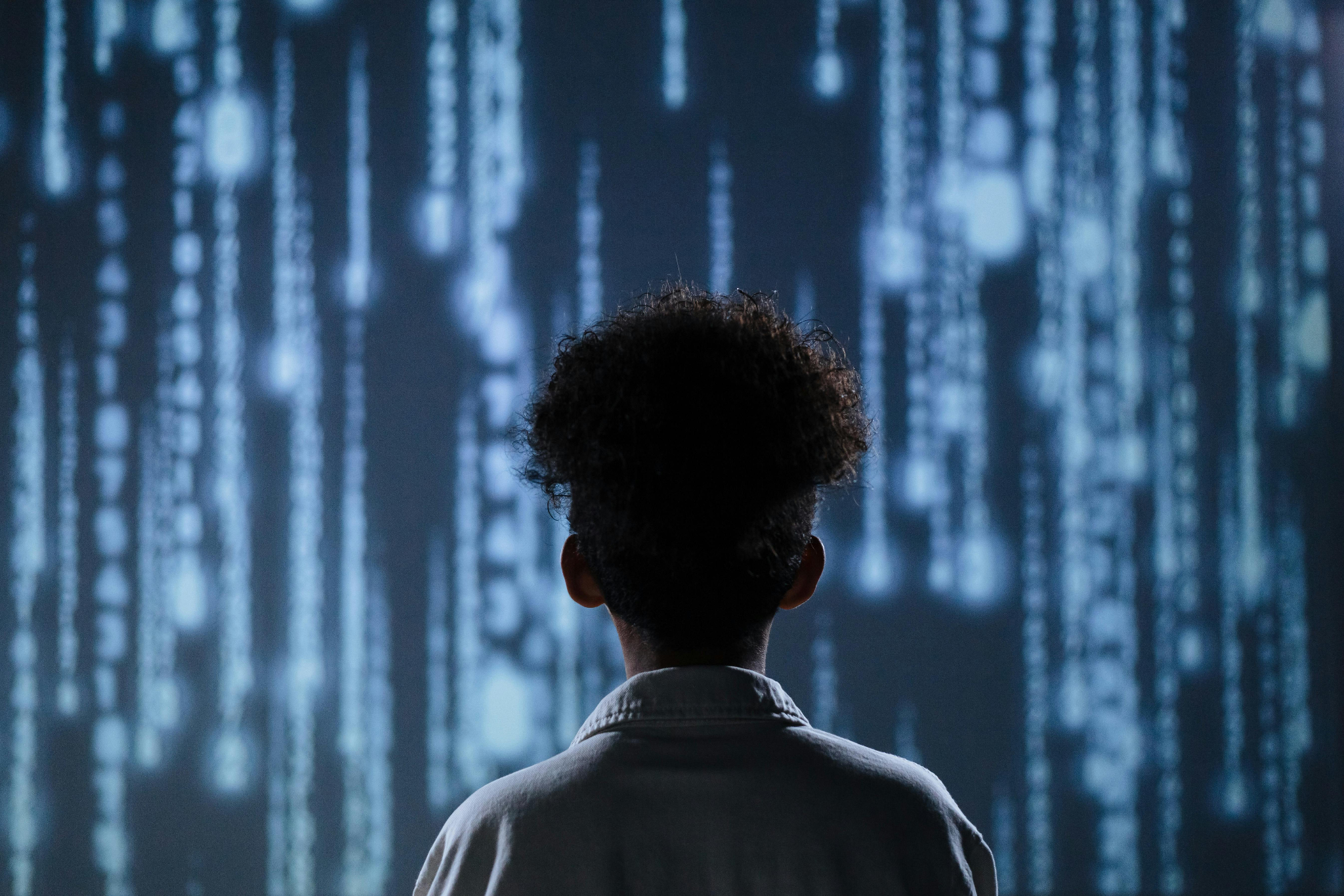 A Kid Looking at a wall with a lot of numbers